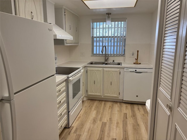 11200 102nd Ave Unit 125, Seminole, FL 33778 - kitchen featuring white appliances, a sink, light countertops, light wood-style floors, and backsplash