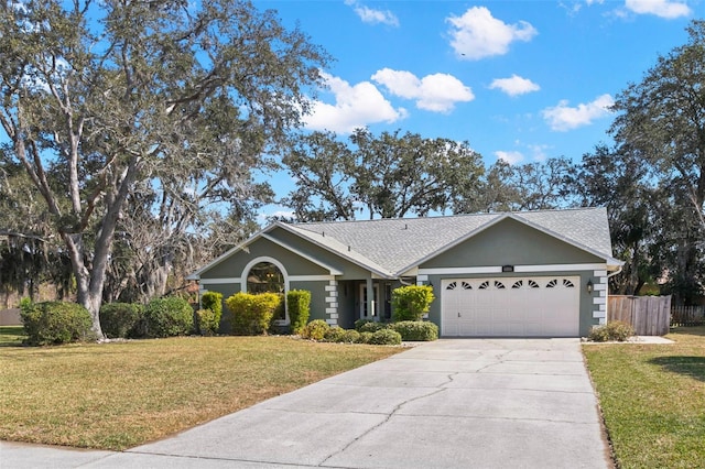 single story home featuring a garage and a front yard