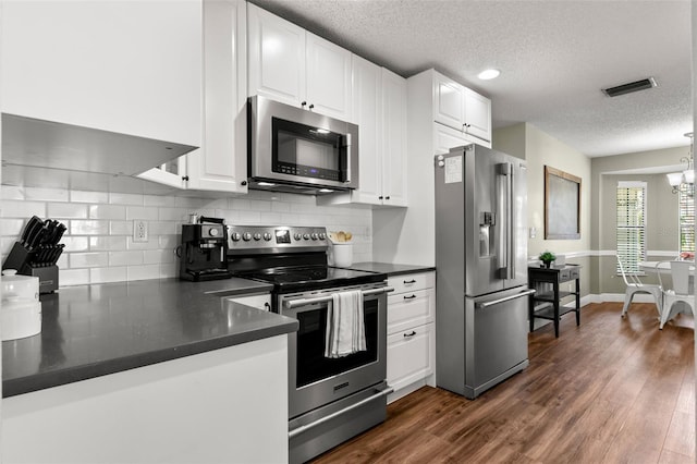 kitchen featuring appliances with stainless steel finishes, dark hardwood / wood-style floors, and white cabinets