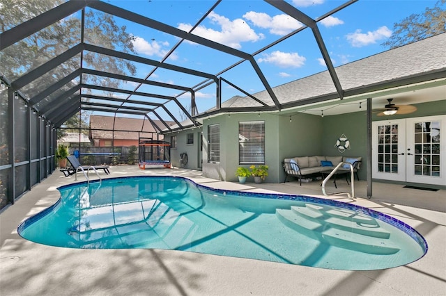 view of pool with a patio, outdoor lounge area, a lanai, ceiling fan, and french doors