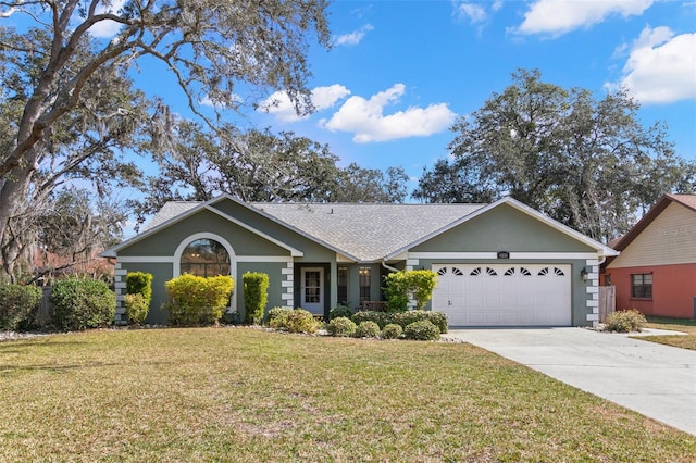 single story home with a garage and a front lawn