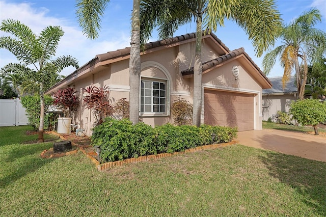 view of front of property with a garage and a front lawn