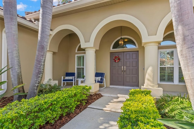 view of exterior entry with covered porch