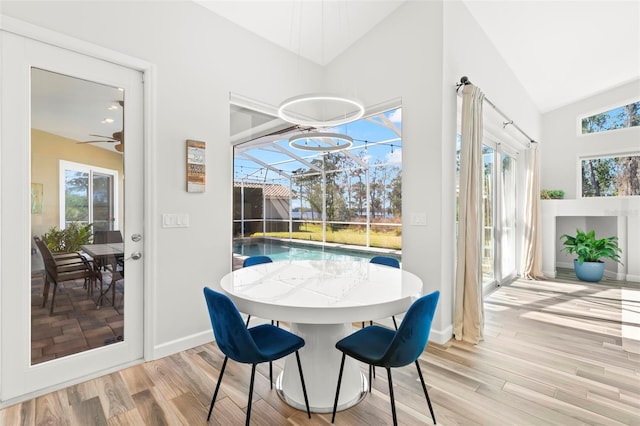 dining space featuring lofted ceiling and light hardwood / wood-style flooring