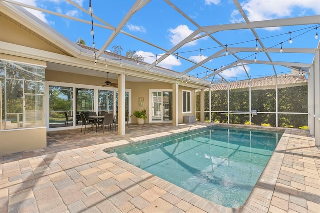 view of pool with a patio, a lanai, and ceiling fan