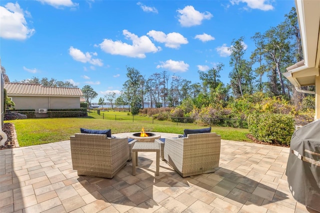 view of patio featuring an outdoor living space with a fire pit and grilling area