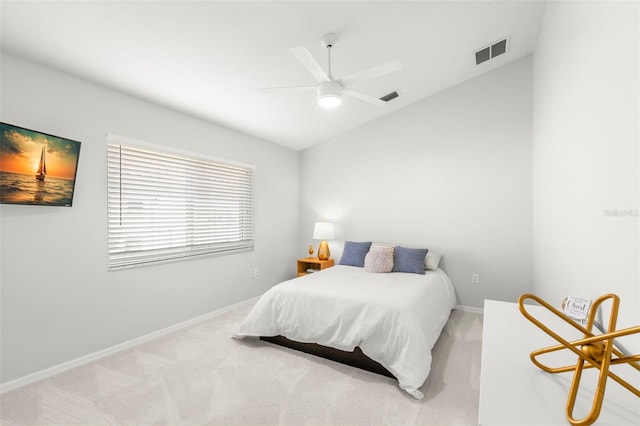 bedroom featuring vaulted ceiling, light carpet, and ceiling fan