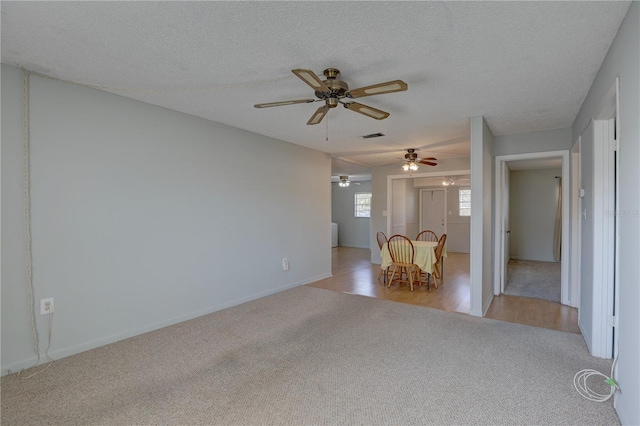 unfurnished room featuring light colored carpet and a textured ceiling