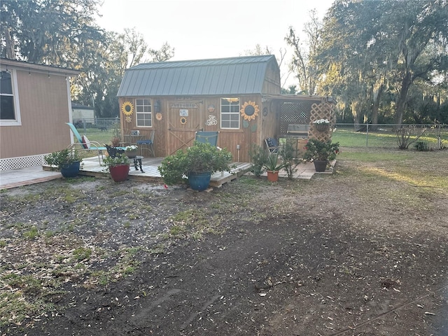 back of property with a storage shed