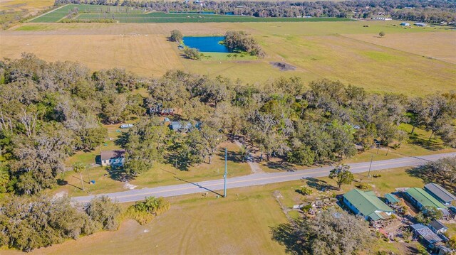 drone / aerial view featuring a water view and a rural view