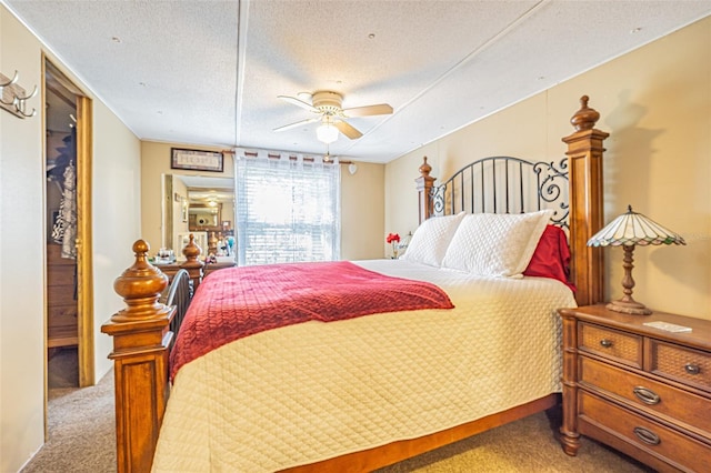 bedroom featuring ceiling fan, a textured ceiling, and carpet flooring