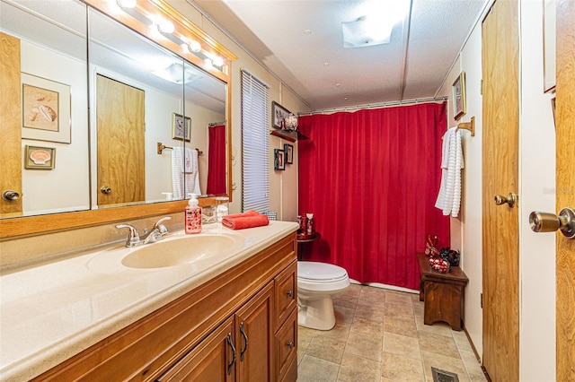 bathroom featuring a shower with curtain, vanity, and toilet