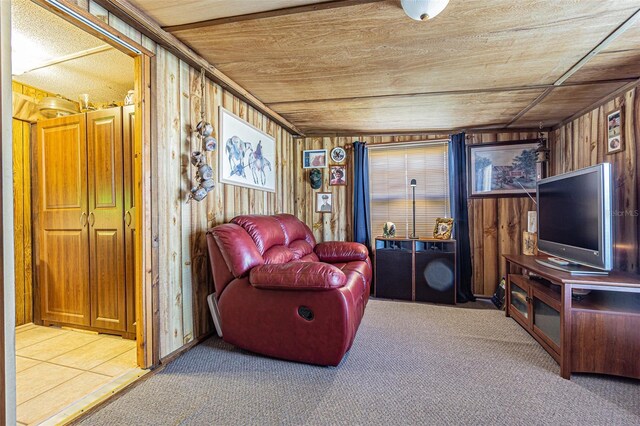 living room with wood walls, carpet floors, and wooden ceiling