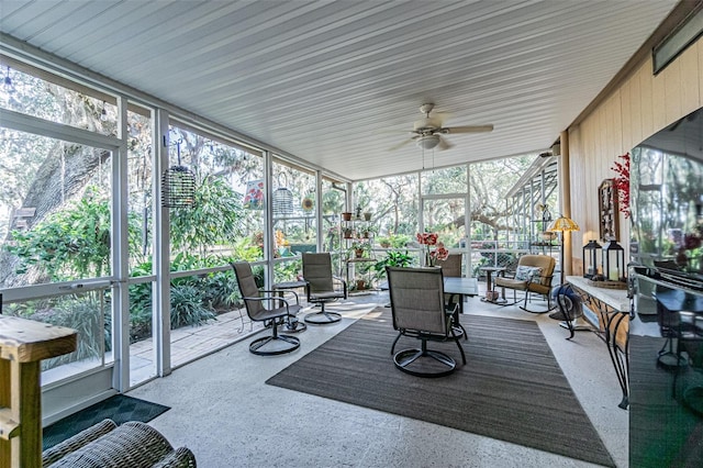 sunroom featuring ceiling fan and a wealth of natural light