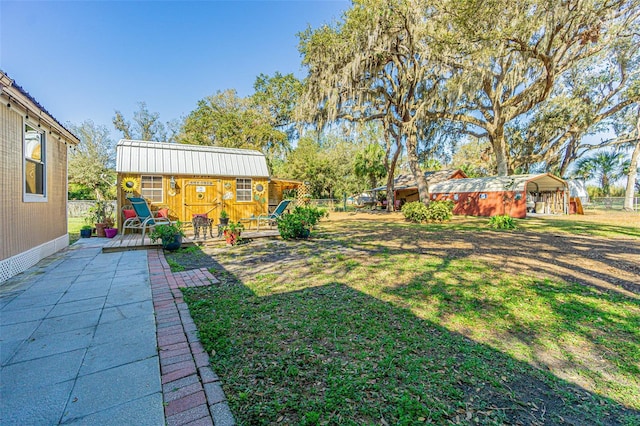 view of yard with a shed and a carport