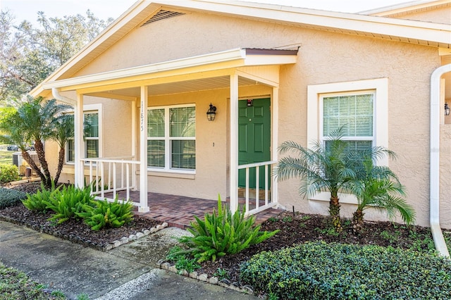 entrance to property featuring a porch