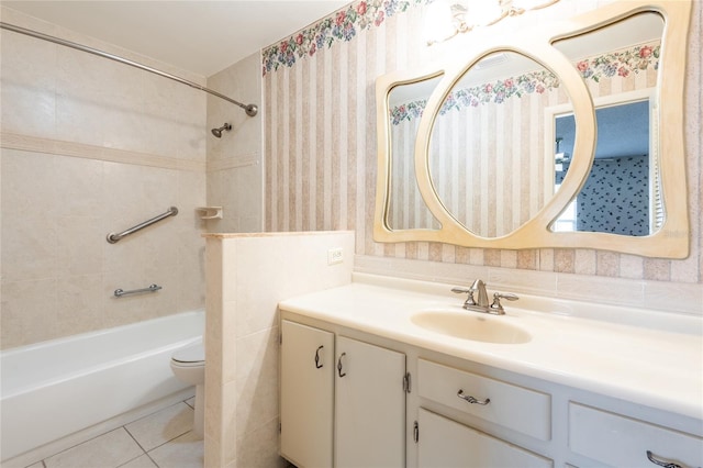 full bathroom featuring vanity, tile patterned flooring, toilet, and tiled shower / bath