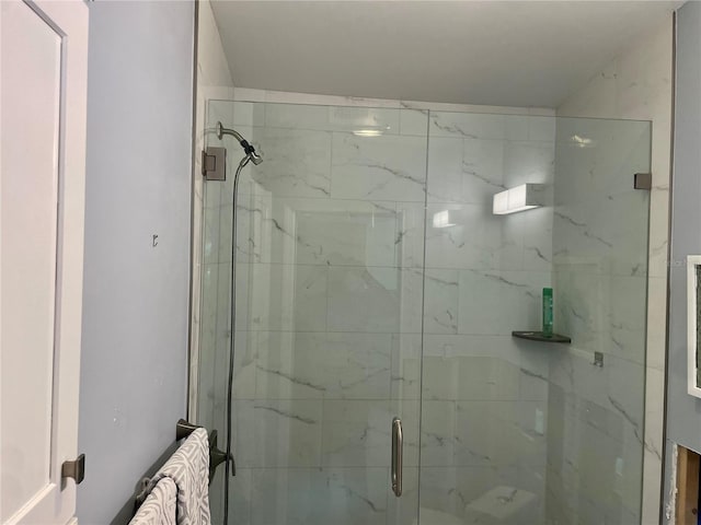 bathroom featuring a shower with shower door