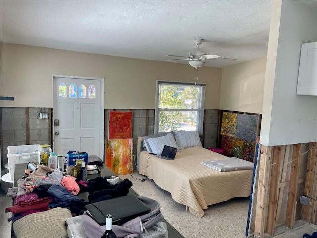 bedroom with ceiling fan and a textured ceiling