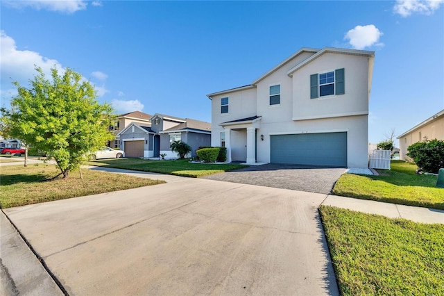 view of front of property with an attached garage, decorative driveway, a front yard, and stucco siding