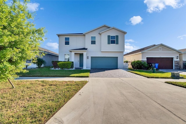 view of front of home with a garage, a front lawn, decorative driveway, and stucco siding