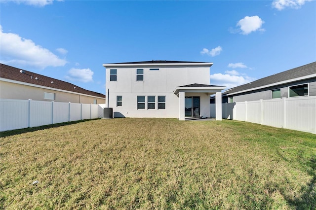 rear view of house with a fenced backyard, cooling unit, a lawn, and stucco siding