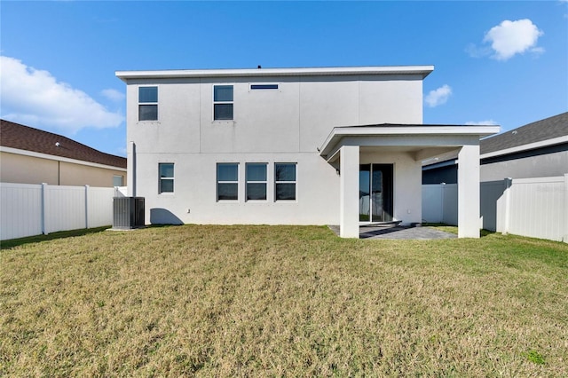 back of property featuring a fenced backyard, a yard, central AC unit, and stucco siding