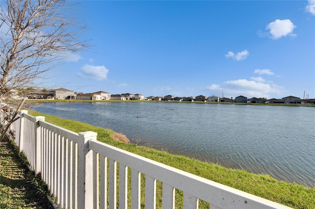 view of water feature featuring a residential view and fence