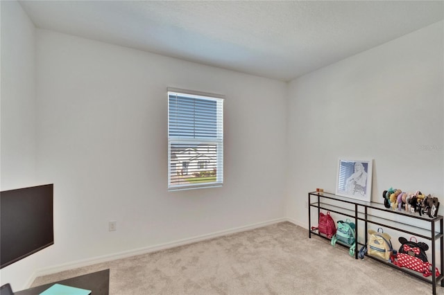 carpeted home office with baseboards