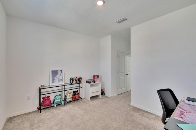 carpeted home office featuring visible vents and baseboards