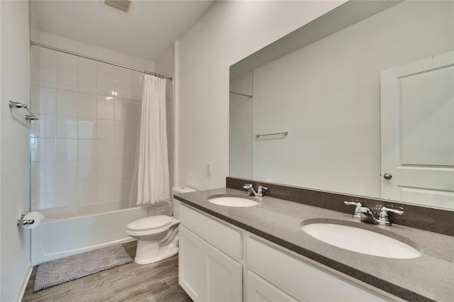 bathroom with visible vents, wood finished floors, a sink, and toilet