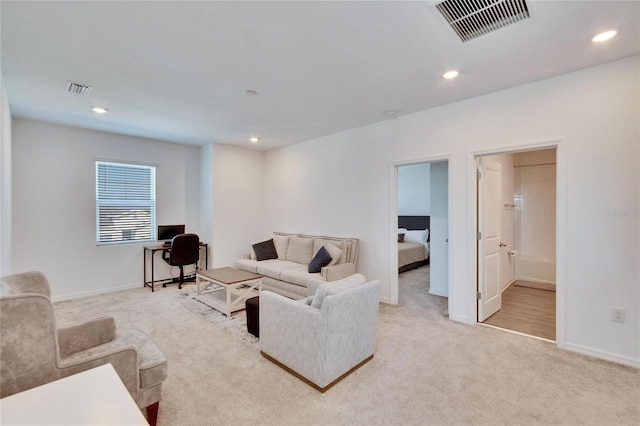 living room featuring visible vents, carpet flooring, and recessed lighting