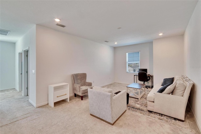 living area featuring light carpet, visible vents, and recessed lighting