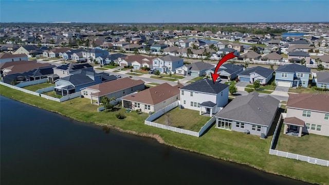 drone / aerial view featuring a residential view and a water view