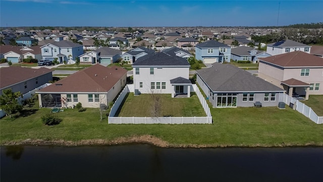 drone / aerial view featuring a water view and a residential view