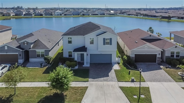 drone / aerial view featuring a water view and a residential view