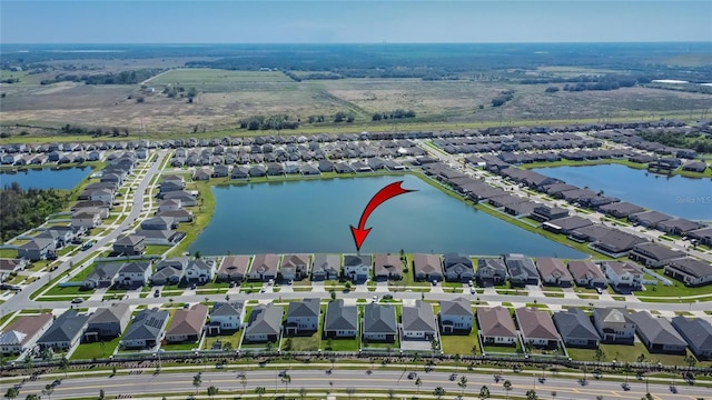 birds eye view of property featuring a water view and a residential view