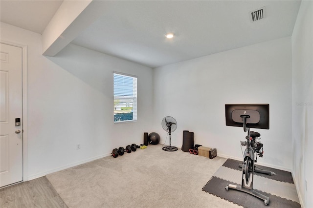 workout room featuring baseboards, visible vents, and carpet flooring