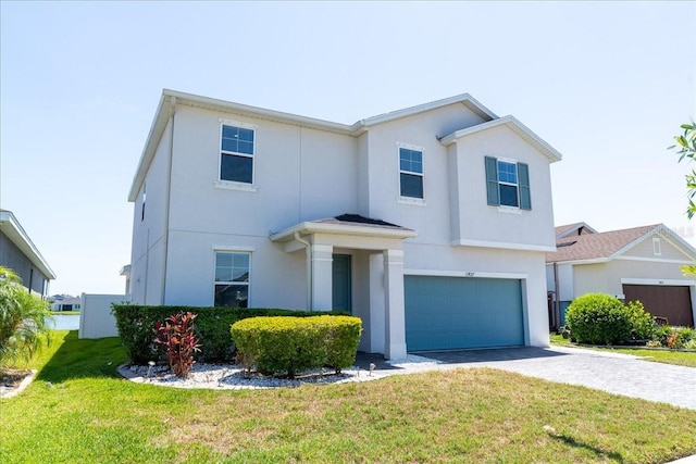11827 Cara Field Ave, Riverview, FL 33579 - view of front of home with a garage, stucco siding, a front lawn, and driveway