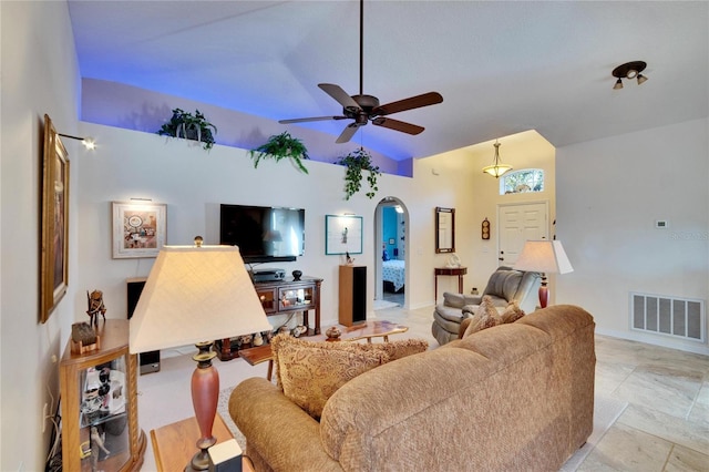 living room with ceiling fan and vaulted ceiling