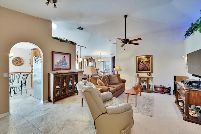 living room featuring ceiling fan with notable chandelier