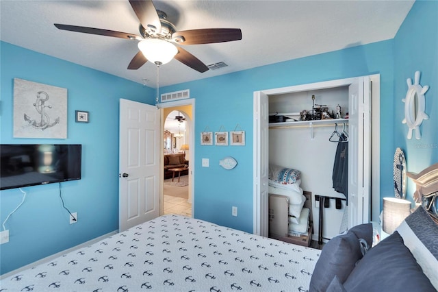 bedroom with ceiling fan and a closet