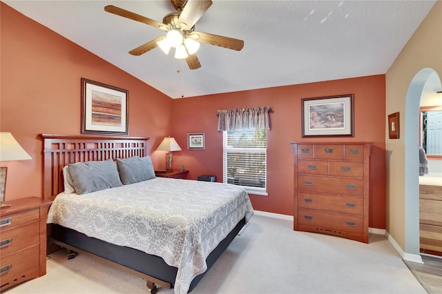 bedroom with lofted ceiling, light colored carpet, and ceiling fan