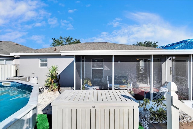 rear view of property with cooling unit and a sunroom