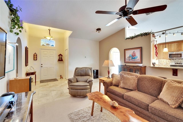 living room with high vaulted ceiling and ceiling fan