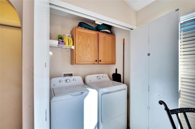 laundry room featuring cabinets and washer and dryer