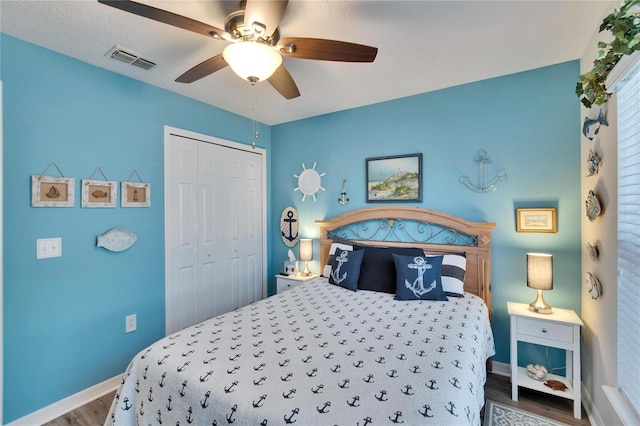 bedroom with ceiling fan, hardwood / wood-style floors, and a closet