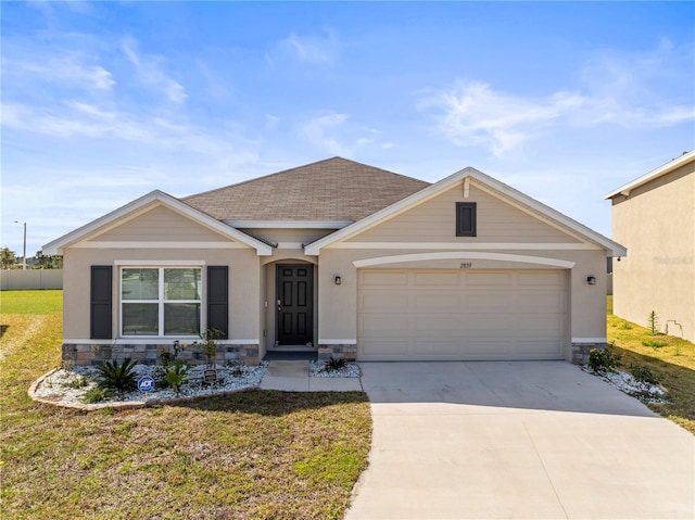 ranch-style home with stone siding, concrete driveway, and a front yard