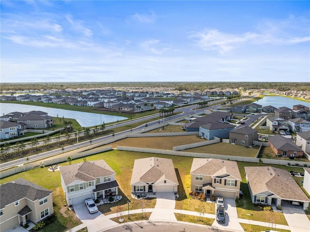 birds eye view of property with a water view and a residential view