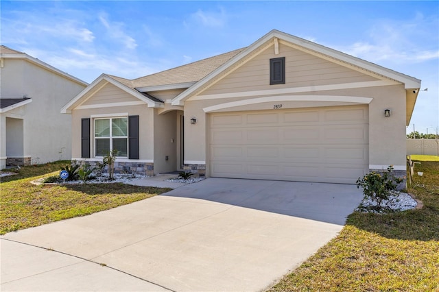 view of front of home with stucco siding, concrete driveway, a garage, stone siding, and a front lawn